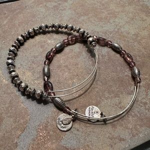 Two Alex and Ani silver bracelets. One has amethyst beading.